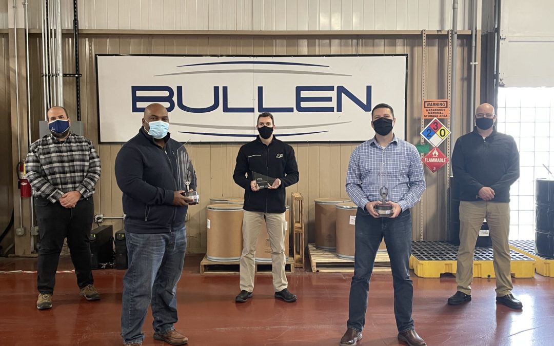 five bullen team members holding awards trophies